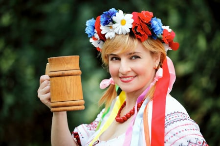 Portrait Happy Ukrainian woman with a wooden mug